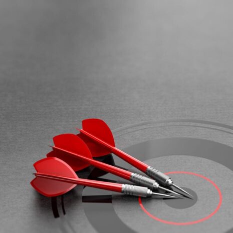Three darts and business target background and copyspace on the left. Marketing and advertising concept.